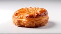 Isolated fresh, ruddy pastry lies on a white glossy surface