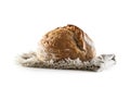 Isolated freshly baked crunchy yeast bread loaf lying on the flax dish cloth Royalty Free Stock Photo