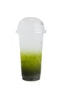 Isolated Front View of Iced Kiwi Soda Drink in plastic cup with plastic cap. Studio shot