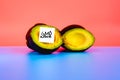 Isolated fruit on flat background labeled with genetically modified food warning sticker