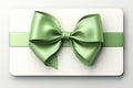 Isolated gift card, adorned with green ribbon bow. Crisp white background. Royalty Free Stock Photo