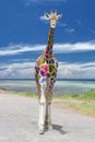 Carnival Arlequin Giraffe coming to you on deep blue sky background