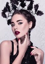Isolated glamour close-up fashion/beauty portrait of a beautiful caucasian girl wearing perfect make-up and unusual accessories Royalty Free Stock Photo