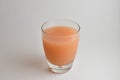 Isolated Glass of fresh pink Grapefruit juice Royalty Free Stock Photo