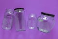 Isolated glass jars, flat and center on violet purple background - recycling