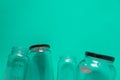 Isolated glass jars, flat on teal mint green background, room for copy space top