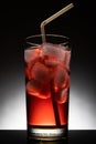 Isolated glass with a red cocktail and ice-cubes Royalty Free Stock Photo