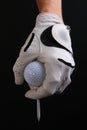 Isolated golf ball, gloved hand and tee Royalty Free Stock Photo