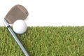 Isolated golf ball on green grass over white background Royalty Free Stock Photo