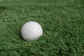 Isolated golf ball on a green synthetic grass Royalty Free Stock Photo