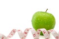 Isolated green apple with measuring tape on white, concept of healthy and diet