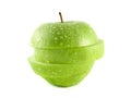 Isolated green apple slices with water drops Royalty Free Stock Photo