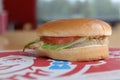 Isolated grilled chicken sandwich at a Wendy\'s restaurant. Out of focus restaurant interior in background. Royalty Free Stock Photo