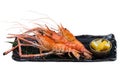 Isolated Grilled shrimps Giant Tiger Pawn with salt served with sliced lemon in black stone plate