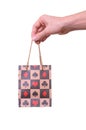 Isolated hand holding shopping paper bag