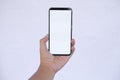 Isolated Hand Holding Smartphone with Blank White Screen on light Background Royalty Free Stock Photo