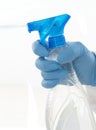 Isolated hand wearing cleaning glove holding a spray bottle Royalty Free Stock Photo