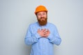 Isolated happy architect with beard and orange helmet