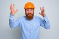 Isolated happy architect with beard and orange helmet