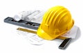 Isolated hard hat with blueprints and rulers