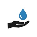 Isolated icon of blue water drop in black hand on white background. Silhouette of aqua drop and hand. Symbol of care, charity. Royalty Free Stock Photo