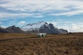 Isolated idyllic abandoned school bus parked in meadow grass field nature landscape near Hofn i Hornafirdi Iceland