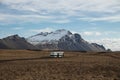 Isolated idyllic abandoned school bus parked in meadow grass field nature landscape near Hofn i Hornafirdi Iceland