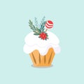 Isolated image of a Christmas muffin. The pastry is decorated with white frosting, candy, red flower and small Christmas tree bran
