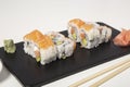 Isolated image of Uramaki plate of salmon, avocado and cheese on white background Royalty Free Stock Photo