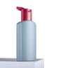Isolated image of a white shampoo bottle resting on a box against a white background Royalty Free Stock Photo