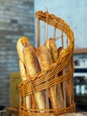Isolated image of a wicker basket filled with a variety of freshly-baked baguettes