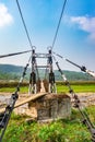 Isolated iron suspension bridge old with blue sky background at morning Royalty Free Stock Photo