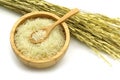 Isolated jasmine rice in a wooden bowl and spoon with ear of rice on white background Royalty Free Stock Photo