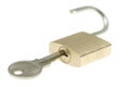 Isolated just-opened brass padlock with key Royalty Free Stock Photo