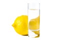 Isolated lemon behind the glass of water Royalty Free Stock Photo