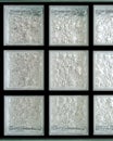 Isolated light transparent square mirror glass block cube and window panel in black background with tiles texture and circle bubbl Royalty Free Stock Photo