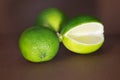 Sliced lime fruits isolated on brown background Royalty Free Stock Photo