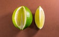 Sliced lime fruits isolated on brown background Royalty Free Stock Photo