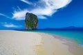 Isolated limestone rock in blue Andaman Sea lagoon, empty white sand beach, clear blue sky with fluffy cloud - Ao Nang, Krabi, Royalty Free Stock Photo