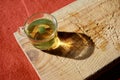 Isolated linden tea on glass cup or pot on wooden plate