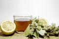 Isolated linden tea and leaves on wooden plate with isolated background.