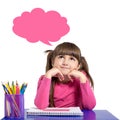 Isolated little girl in a pink shirt is sitting at the table wit Royalty Free Stock Photo