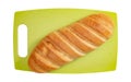 Isolated loaf of bread on green cutting board on white background. Royalty Free Stock Photo