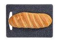 Isolated loaf of bread on grey rectangular cutting board on white background.