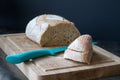 Loaf of bread and knife over dark background Royalty Free Stock Photo