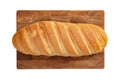 Isolated loaf of bread on wooden rectangular cutting board on white background.