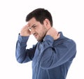 Isolated man in blue shirt with pains in the neck.