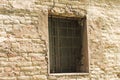 Isolated medieval window with iron gratings Royalty Free Stock Photo