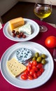 Isolated Mediterranean meal: cheeses, olives, tomatoes and olive oil