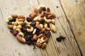 Isolated mixed nuts and dried fruits in the heart shape on the rustic background Royalty Free Stock Photo